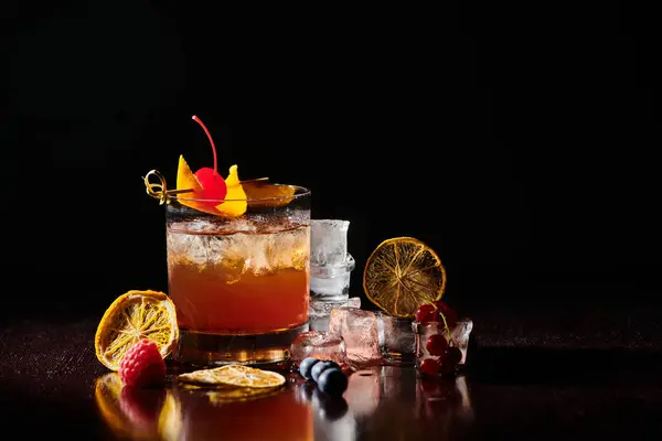 Thirst quenching negroni garnished with cocktail cherry on black background, concept — Stock Photo