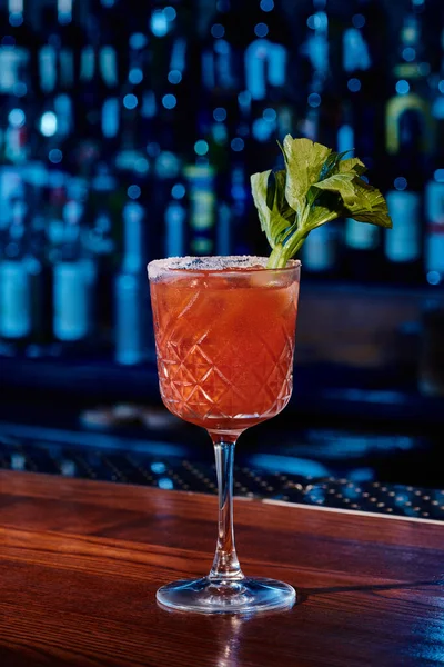 Sophisticated bloody mary cocktail decorated with celery stalk on bar counter, concept — Stock Photo