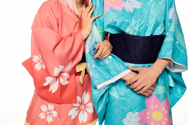 Обрезанный вид пары аниме в ярких и элегантных кимоно на белой японской субкультуре косплея — стоковое фото