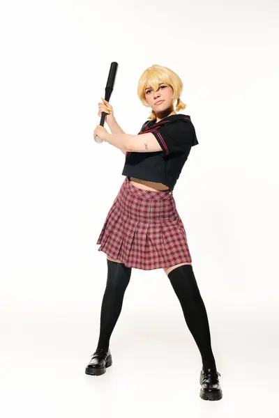Full length of displeased woman in in school uniform with baseball bat on white, anime character — Stock Photo