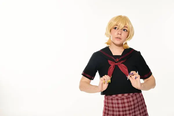 Dreamy woman in blonde wig touching red neckerchief and looking away on white, anime style concept — Stock Photo
