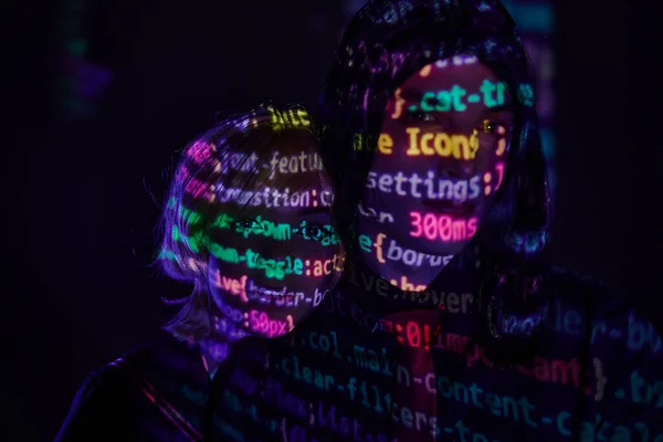 Portrait of futuristic couple with neon programming lettering on dark backdrop, cosplay concept — Stock Photo