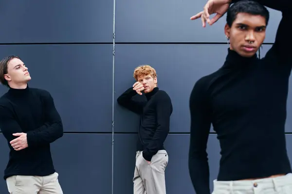 Good looking interracial group of men posing next to wall in casual black turtlenecks, fashion — Stock Photo