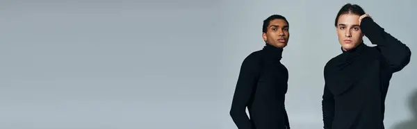 Classy multicultural male models posing in black turtlenecks and looking at camera, banner — Stock Photo