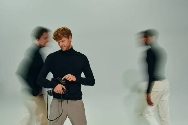Red haired man with retro phone with motion blur of other male models, long exposure, men power — Stock Photo