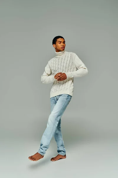 Handsome stylish african american man in warm sweater and jeans looking away, fashion concept — Stock Photo
