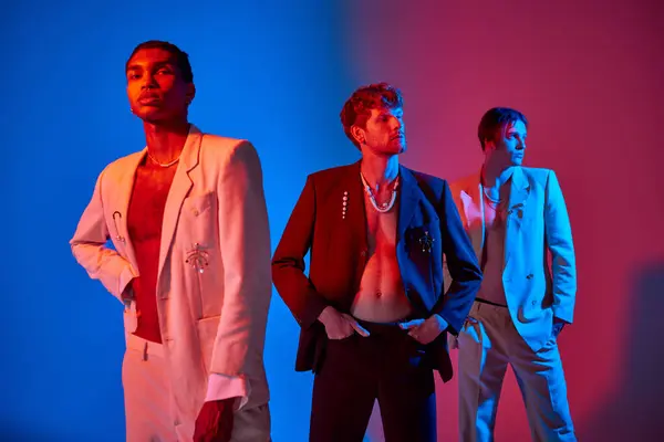 Appealing diverse male models in elegant suits posing with neon lights on their faces, men power — Stock Photo