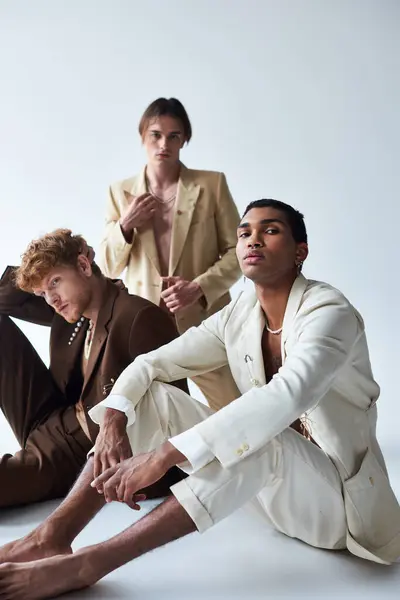 Good looking diverse men in elegant suits with accessories posing on floor, fashion concept — Stock Photo