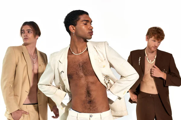 Appealing sexy multicultural male models in unbuttoned suits with stylish accessories, men power — Stock Photo