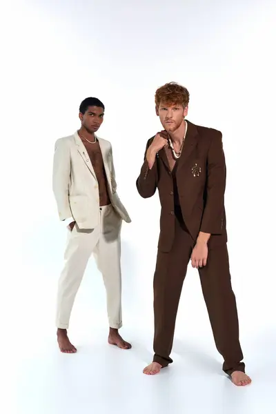 Handsome elegant diverse men in suits posing lively on white backdrop, looking at camera, fashion — Stock Photo