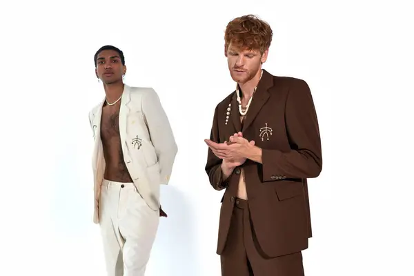 Handsome appealing diverse men in suits with accessories posing on white backdrop, fashion concept — Stock Photo