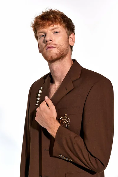 Portrait of appealing sexy man in elegant suit with accessories looking at camera, fashion concept — Stock Photo