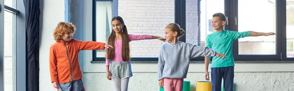 Little pretty children in sportswear stretching arms, looking at each other, child sport, banner — Stock Photo