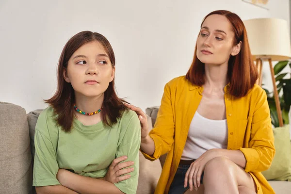 Caring mother calming frustrated teenage daughter on couch in living room, supportive parent — Stock Photo