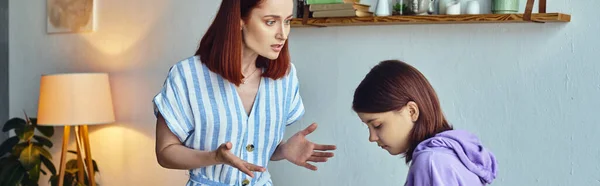 Displeased woman gesturing and quarreling with upset teenage daughter at home, horizontal banner — Stock Photo