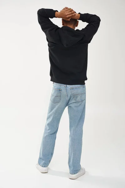 Trendy african american male model in casual black hoodie and jeans, copy space for advertising — Stock Photo