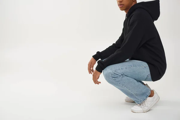 Trendy african american male model in casual black hoodie and jeans, copy space for advertising — Stock Photo