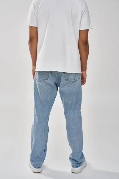 Stylish african american man in trendy casual jeans and white t-shirt, copy space for advertising — Stock Photo