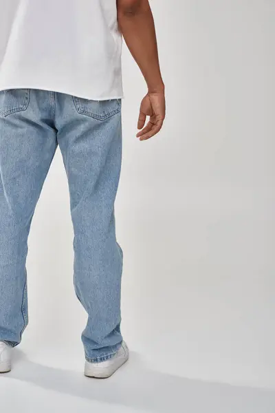 Stylish african american man in trendy casual jeans and white t-shirt, copy space for advertising — Stock Photo