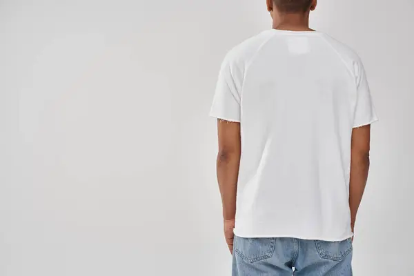Stylish african american man in trendy casual jeans and white t-shirt, copy space for advertising — Stock Photo
