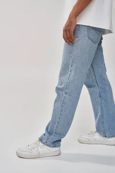 Stylish african american man in trendy casual jeans and white t-shirt, copy space for advertising — Stock Photo