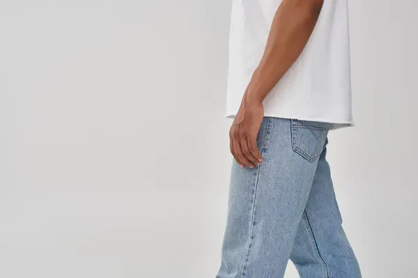 Stylish african american man in trendy casual jeans and white t-shirt, copy space for advertising — Stock Photo