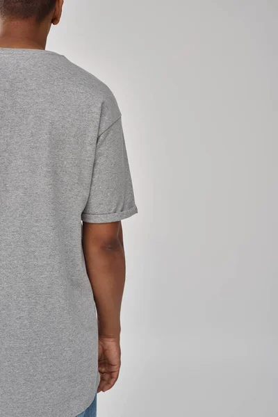 Stylish african american man in trendy casual jeans and gray t-shirt, copy space for advertising — Stock Photo