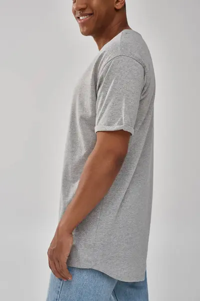 Stylish african american man in trendy casual jeans and gray t-shirt, copy space for advertising — Stock Photo