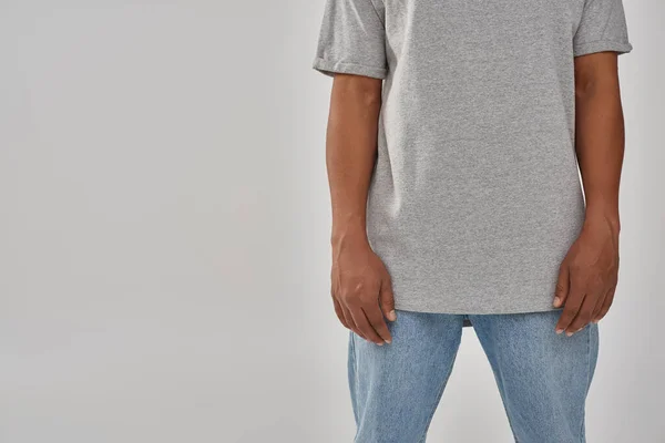 Stylish african american man in trendy casual jeans and gray t-shirt, copy space for advertising — Stock Photo