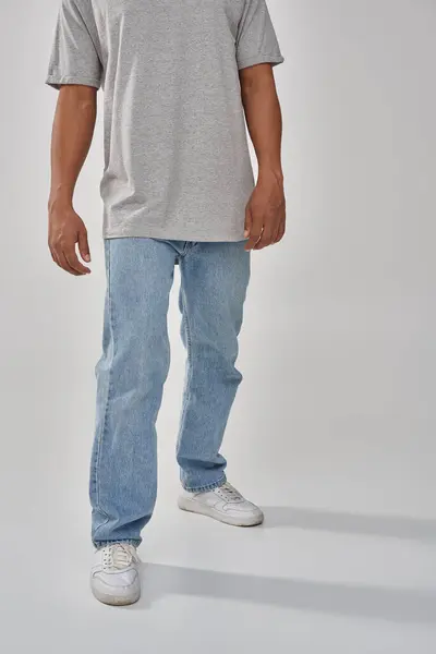 Stylish african american man in trendy casual jeans and gray t-shirt, copy space for advertising — Stock Photo