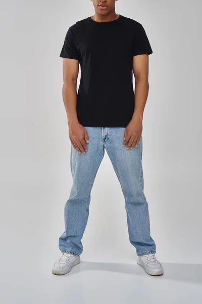 Stylish african american male model posing in black t-shirt and jeans, copy space for advertising — Stock Photo