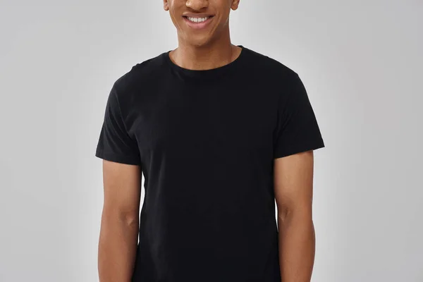 Happy fashionable african american man in casual stylish black t-shirt, copy space for advertising — Stock Photo