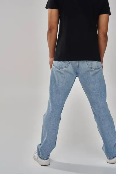 Stylish african american male model posing in black t-shirt and jeans, copy space for advertising — Stock Photo