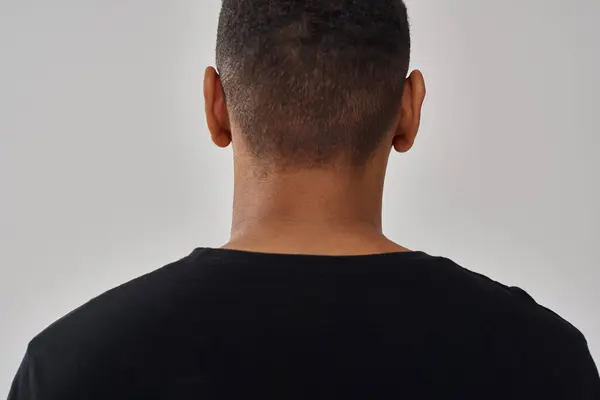 Fashionable african american man in casual stylish black t-shirt, copy space for advertising — Stock Photo