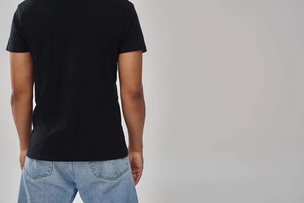 Stylish african american male model posing in black t-shirt and jeans, copy space for advertising — Stock Photo