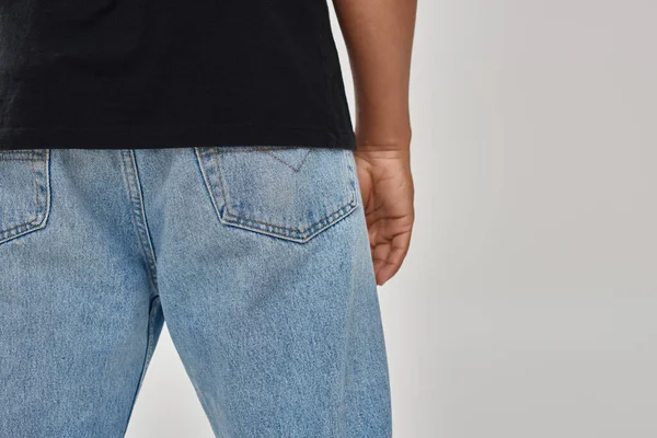 Stylish african american male model posing in black t-shirt and jeans, copy space for advertising — Stock Photo