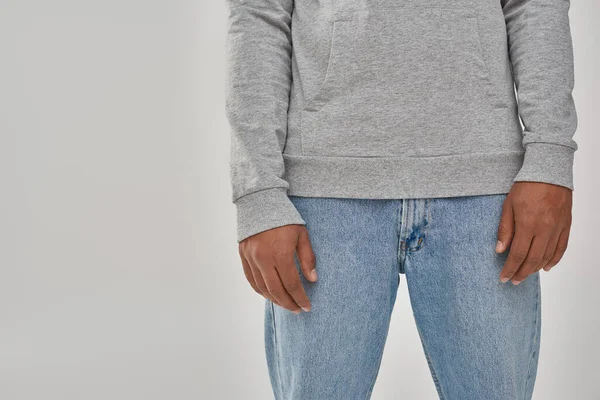 Stylish african american man in gray casual sweatshirt and jeans, copy space for advertising — Stock Photo
