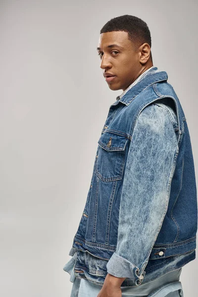 Good looking african american man in stylish denim outfit posing in motion, fashion concept — Stock Photo