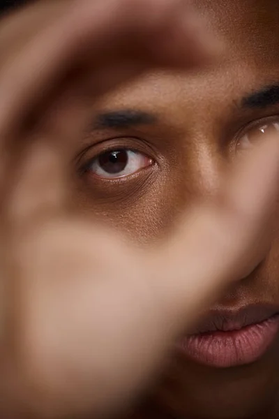 Close up of handsome appealing african american man with hand in front of face, fashion concept — Stock Photo