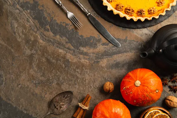 Rustic thanksgiving backdrop with ripe pumpkins, vintage cutlery and ripe pumpkins on stone table — Stock Photo