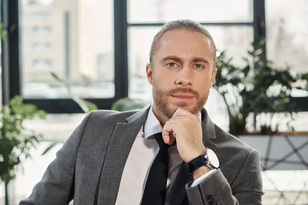 Professional headshot of successful and stylish businessman looking at camera in contemporary office — Stock Photo