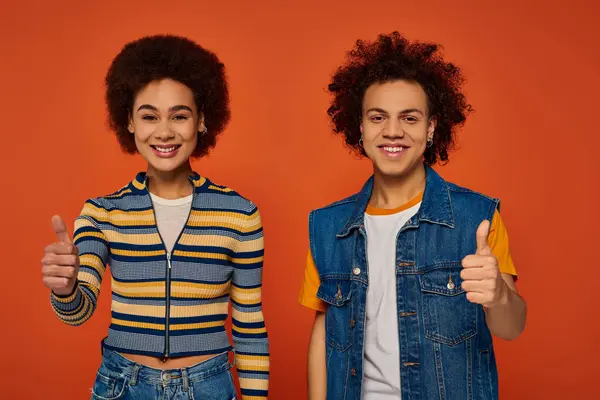 Joyful african american brother and sister gesturing actively and looking at camera, family — Stock Photo