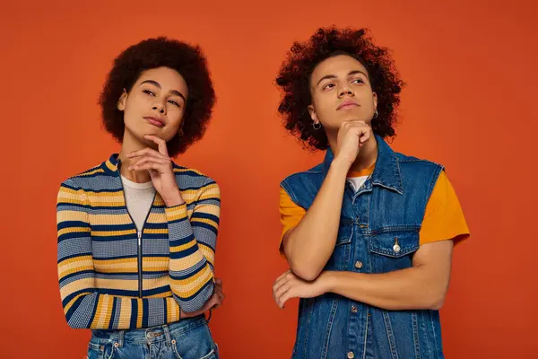 Young african american brother and sister gesturing actively and looking at camera, family concept — Stock Photo