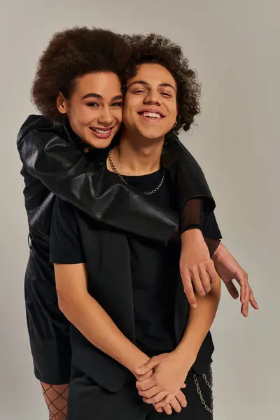 Jolly stylish african american brother and sister in trendy outfits hugging and smiling happily — Stock Photo