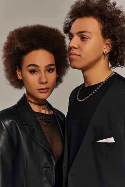 Jeune frère afro-américain à la mode et soeur en vêtements urbains posant ensemble sur fond gris — Photo de stock