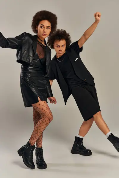 Appealing african american siblings in trendy black outfit posing together on gray backdrop, family — Stock Photo