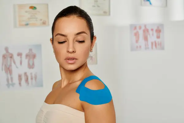 Attractive female patient with kinesiological tapes on her body in medical ward, healthcare — Stock Photo