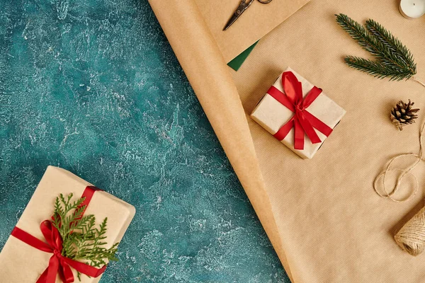 Present boxes and craft paper with twine and decor supplies on blue textured surface, Christmas — Stock Photo