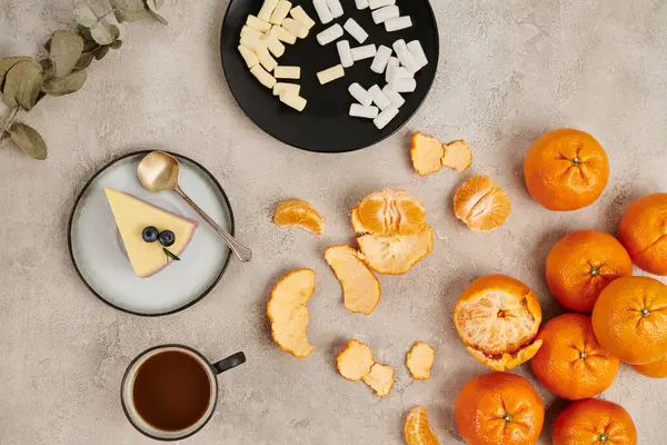 Christmas treats, pudding and marshmallows near hot chocolate on grey surface with tangerines — Stock Photo