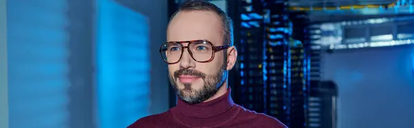 Joyful focused data center specialist in turtleneck with beard and glasses looking away, information — Stock Photo